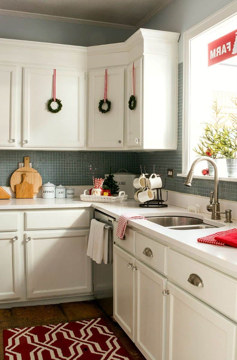 small wreaths on white cabinets in kitchen for christmas