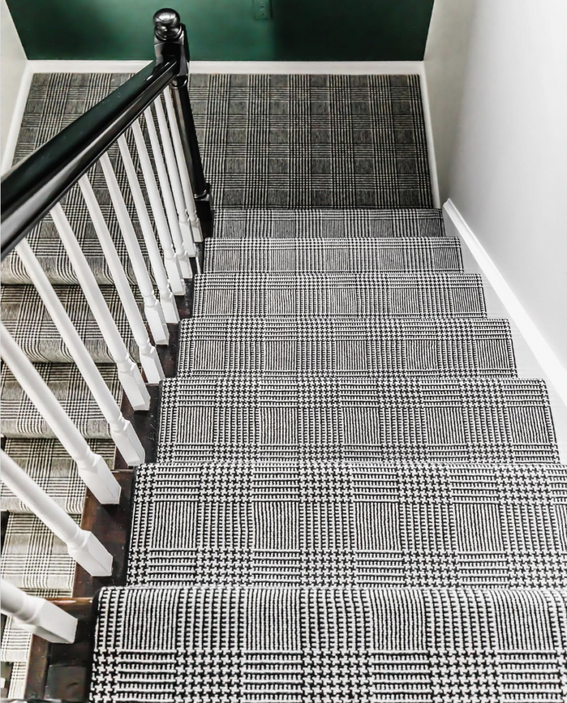 A Checkered Carpet Runner in Black and White Paired with Green Walls