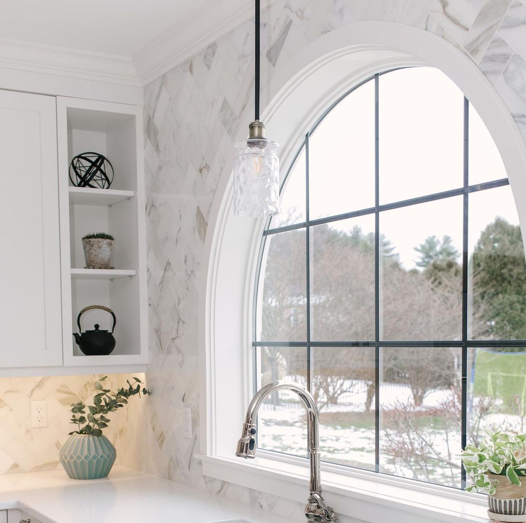 A large curved kitchen window with an arch