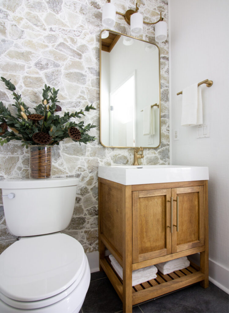 A Stone Wall Brings Rustic Style to a Small Bathroom