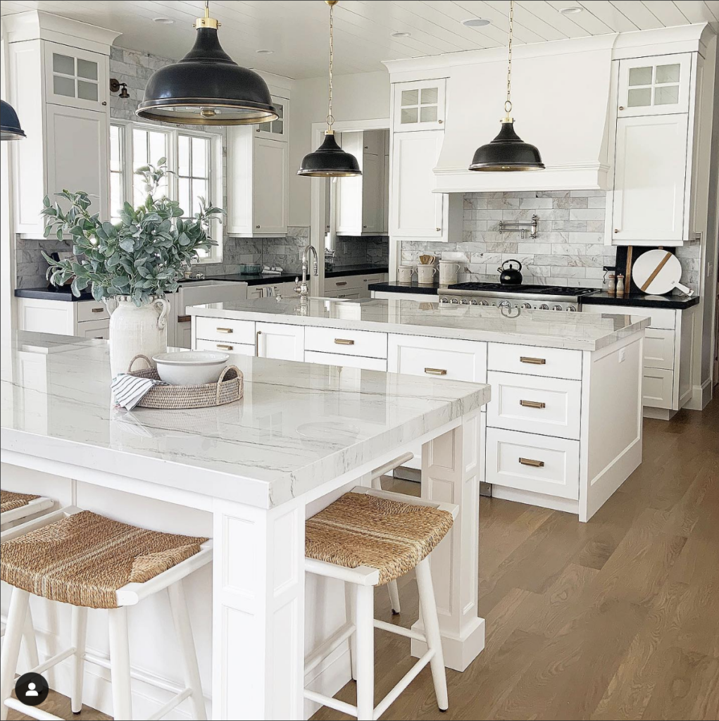 A White Cabinet and Stainless Steel Appliance Pairing with Black Granite Countertops