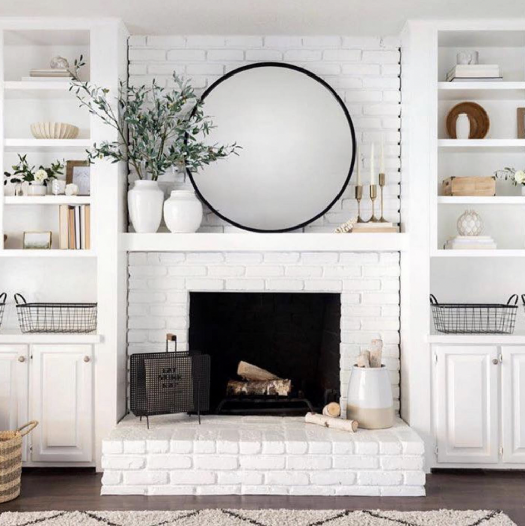 A White Stone Fireplace and Its Brick Hearth