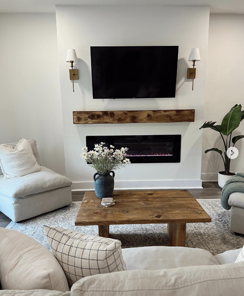 Electric fireplace surround with TV mounted above in balanced arrangement