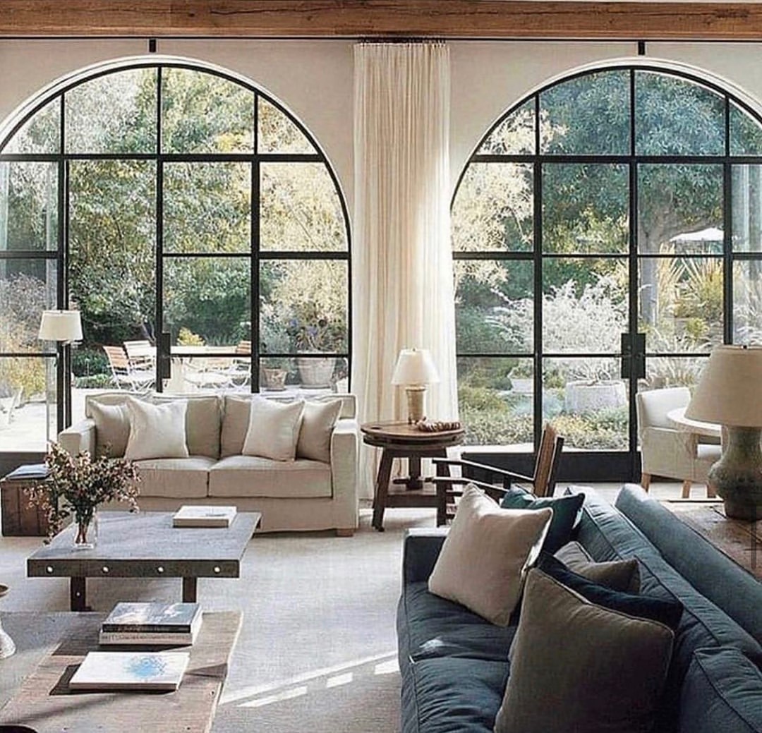 Arched Window and Subtle Wood Beam in a Light-Filled Living Room