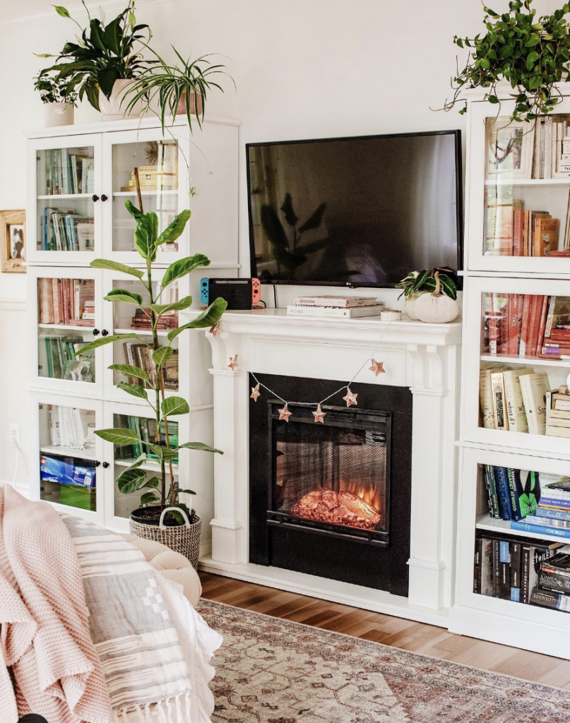 Bedroom TV Above Fireplace with Two Built-Ins