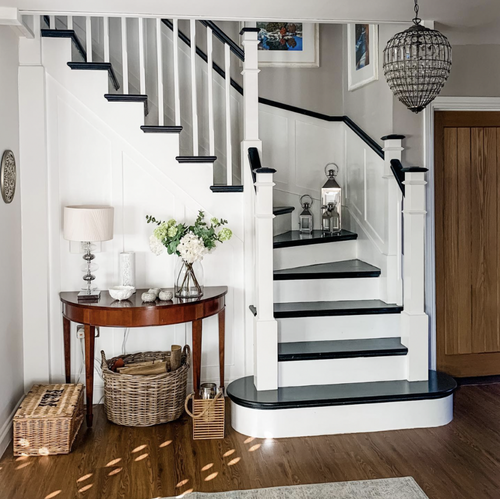 Black-and-white stairs with a dark wood floor