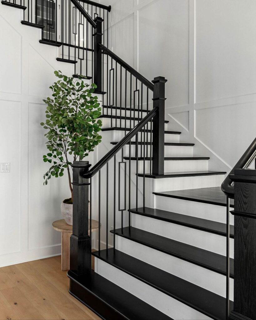 Black Banister and Steps by White Board and Batten Walls