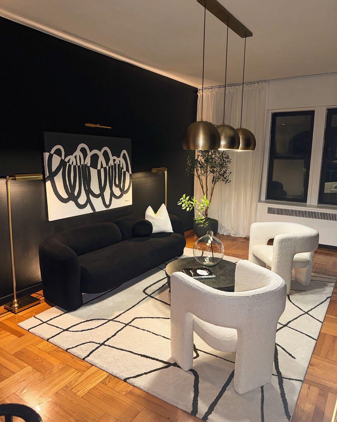 Black Couch with Bold Art and Metallic Highlights