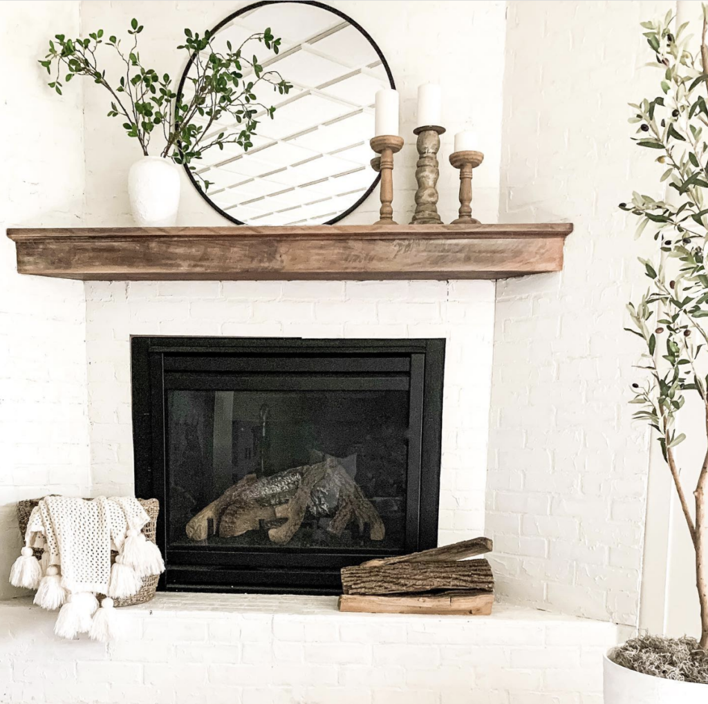 Black Fireplace Framed in White Brick
