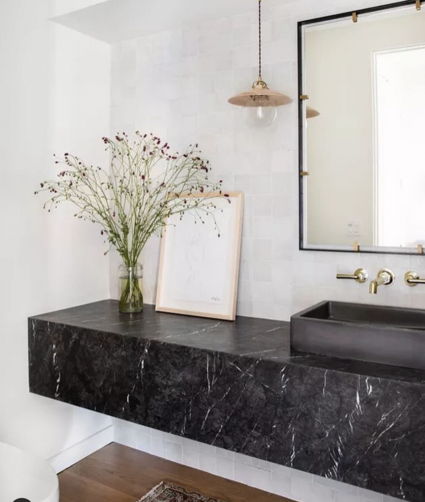 Black granite above dark wood in a floating countertop arrangement