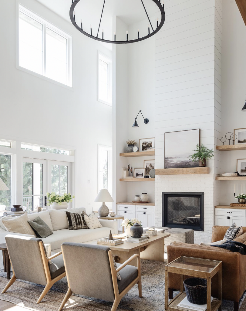 Black Industrial Sconces Next to a White Brick Fireplace