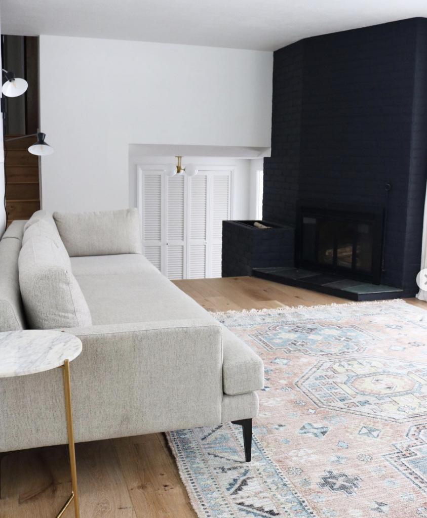 Black Off Center Painted Brick Fireplace