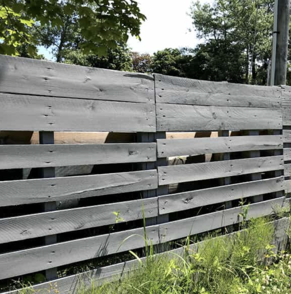 Black Painted Pallet Wood Privacy Fence with Bold Lines