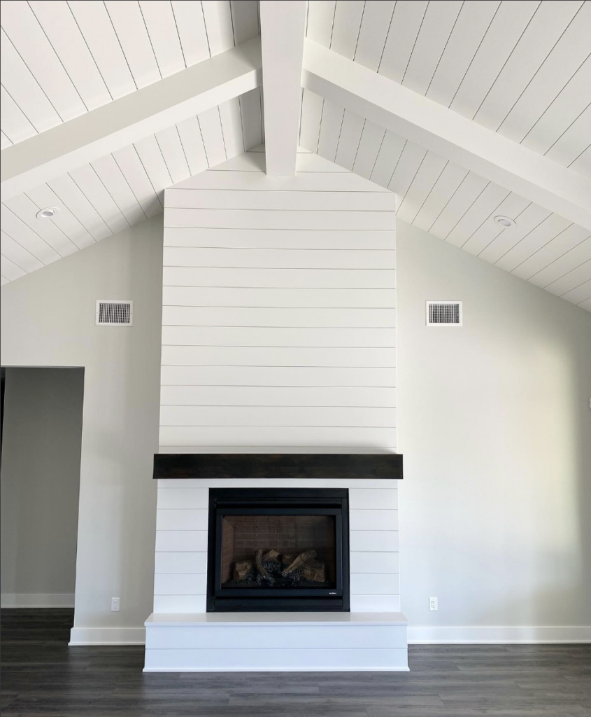 Black Shiplap Fireplace with Dark Wood Floor