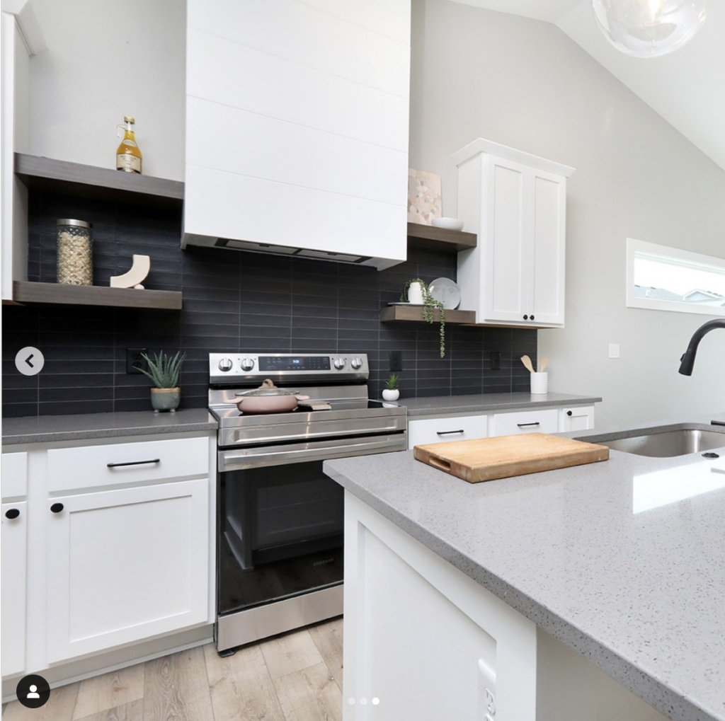 Light Grey Countertops With Black Tile Backsplash