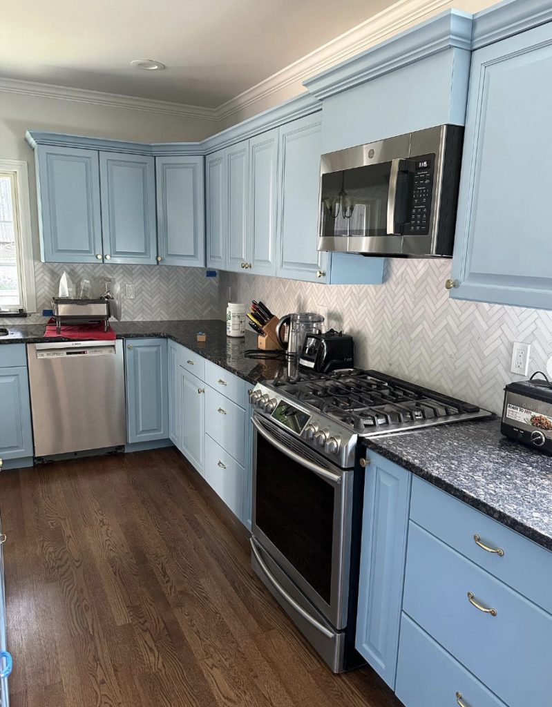 Blue Cabinets Framed by Trim With Granite Counters