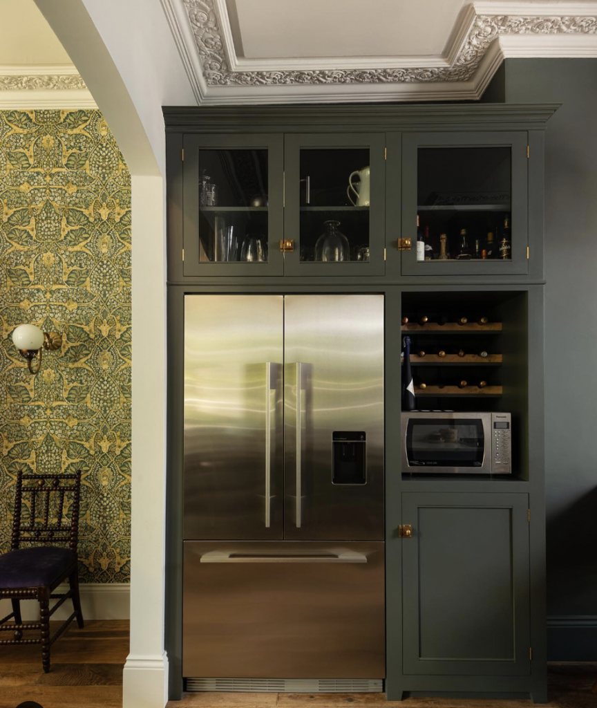 Brass Hardware on a Forest Green Cabinet Above the Refrigerator