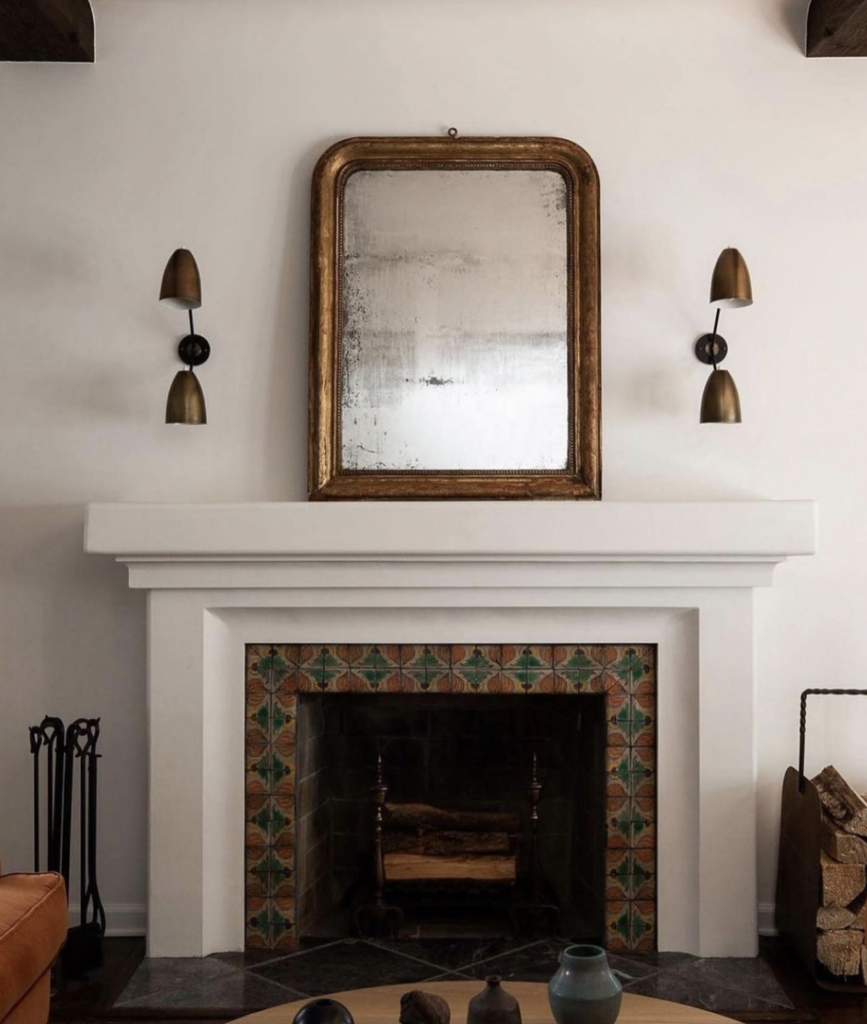 Brass Sconces Above a Brass-Framed Mirror