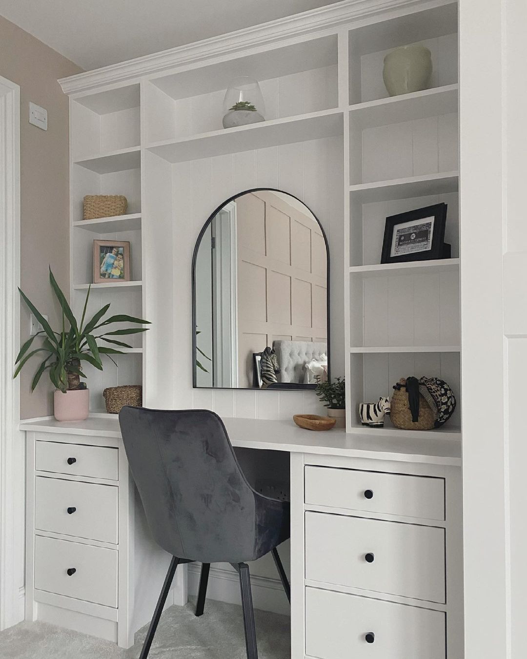 Built-In Mirror and Open Shelf Attached to a Spacious White Built-In Desk