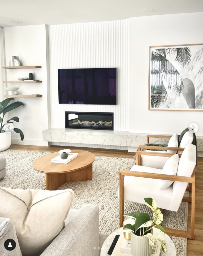 Electric fireplace with TV above flanked by custom built-in shelving