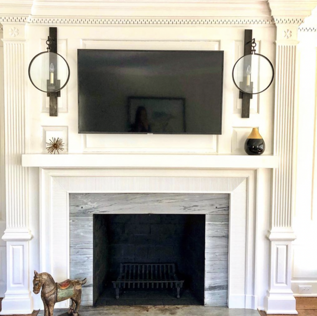 Chandelier Sconces and a TV Over the Fireplace