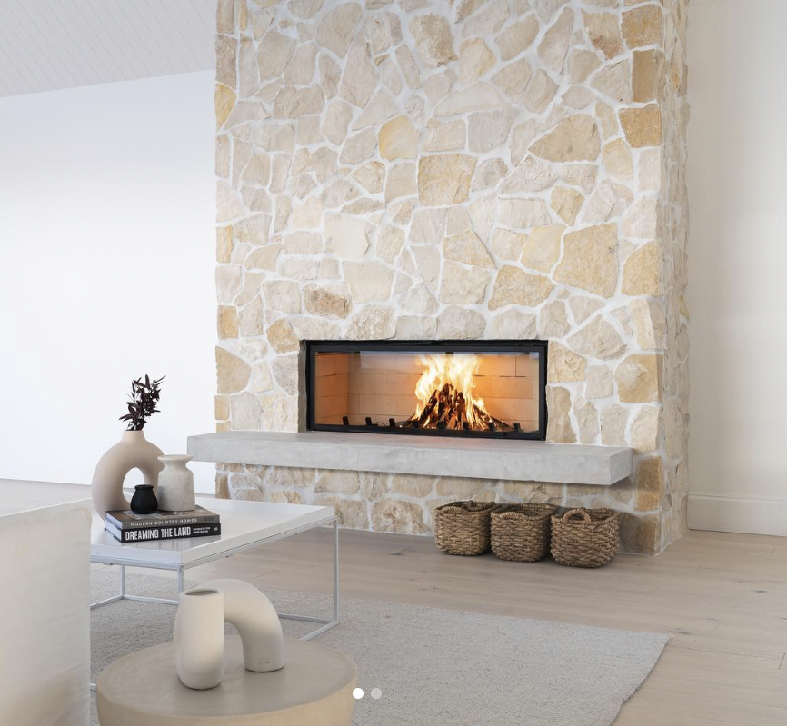 Concrete Hearth Beneath an Exposed Stone Fireplace