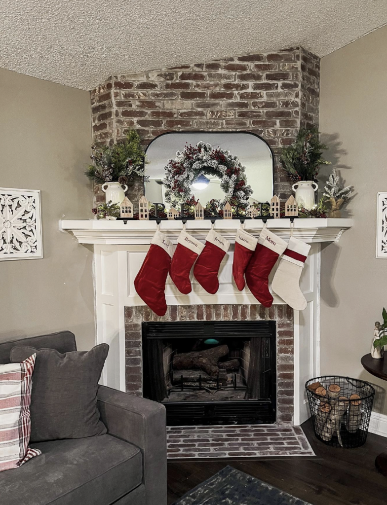 Corner fireplace in brick with a mirror overhead