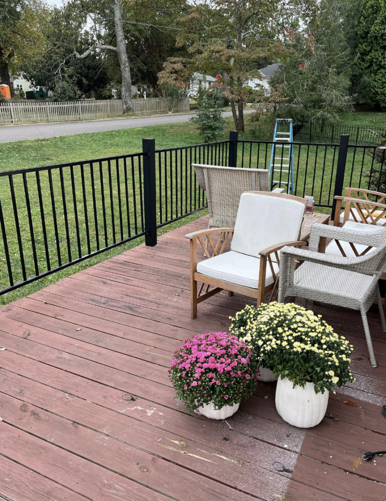 Dark Pallet Wood Patio with a Black Porch Railing