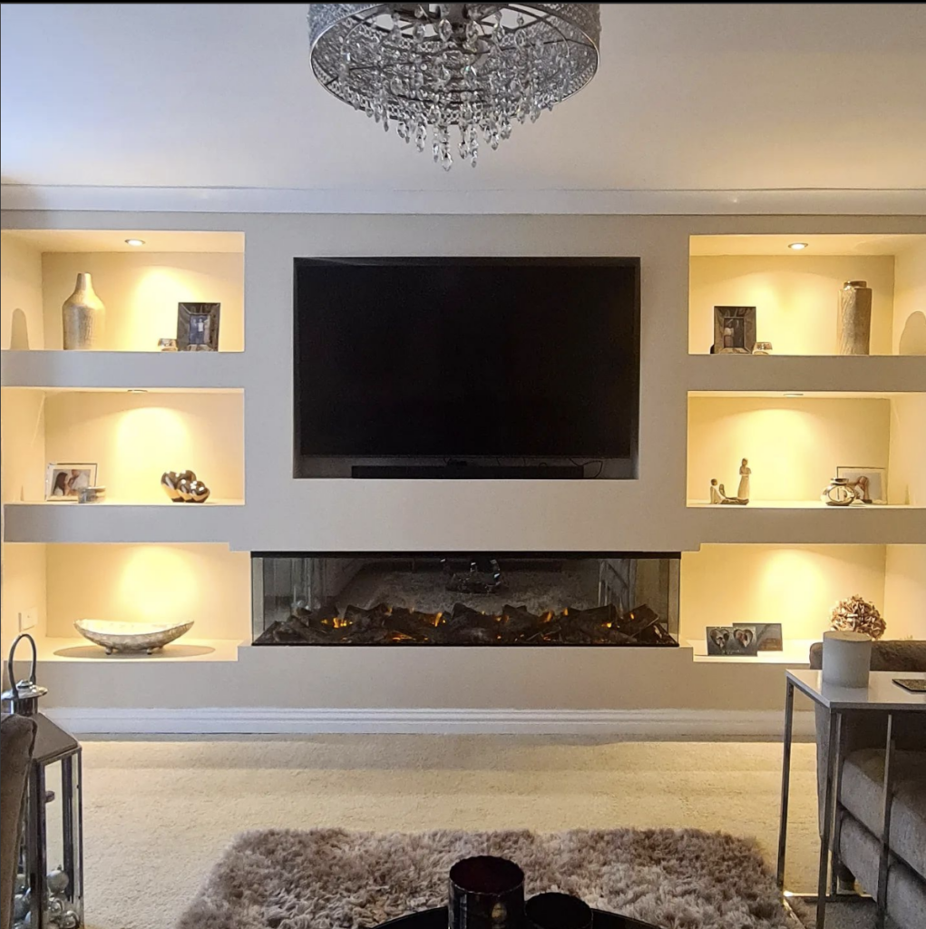 Electric fireplace with TV above flanked by built-in cabinetry on both sides