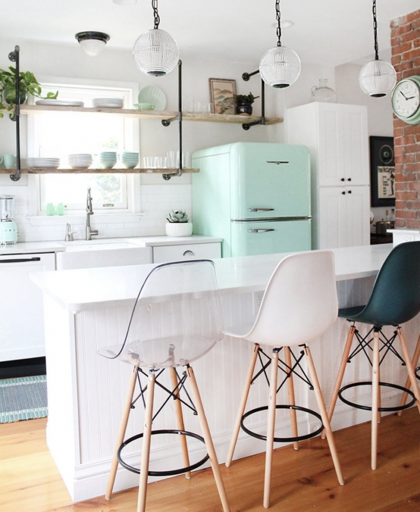 Floating Wood Shelf Above a Blue Fridge in a Small White Kitchen