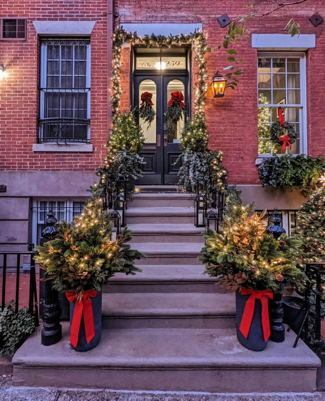 Front door steps of cement with Christmas decor