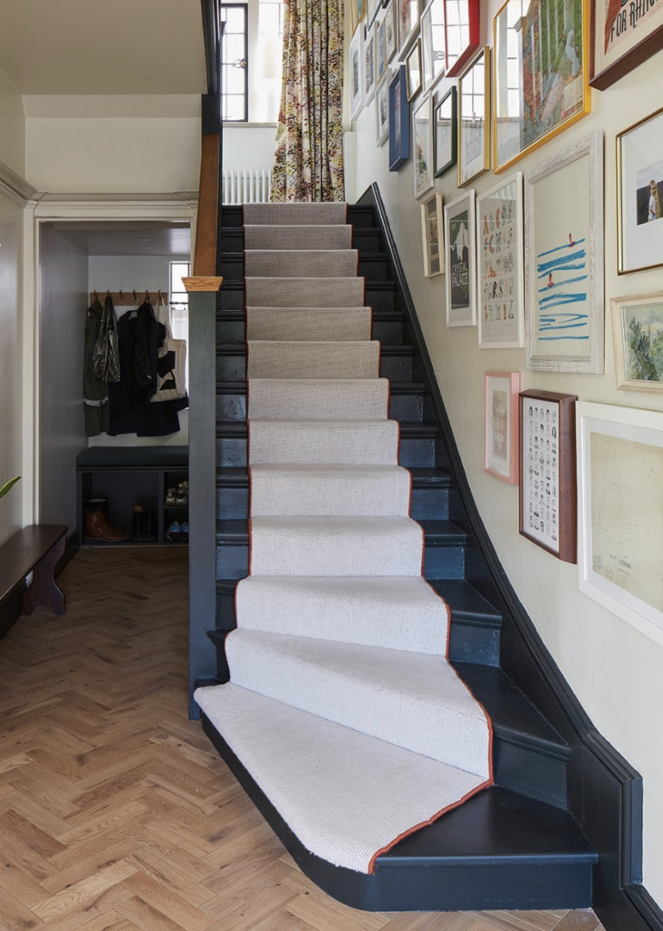 Gallery Wall with a Black Staircase and Skirt Trim