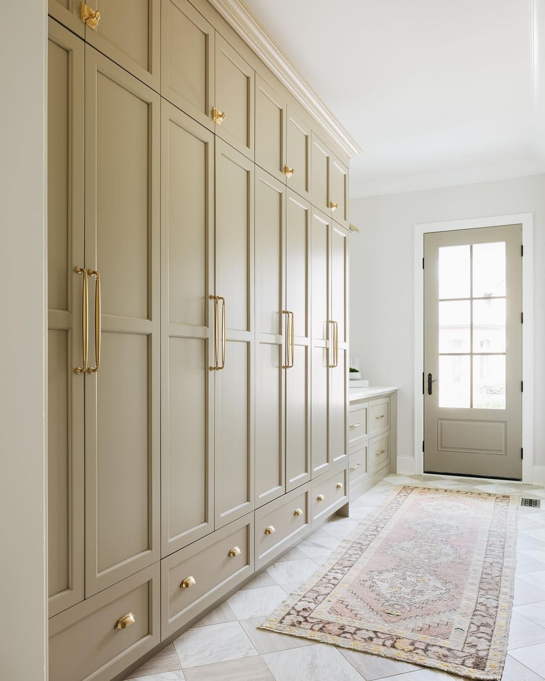 Gold Accents on a Light Airy Mudroom Wall