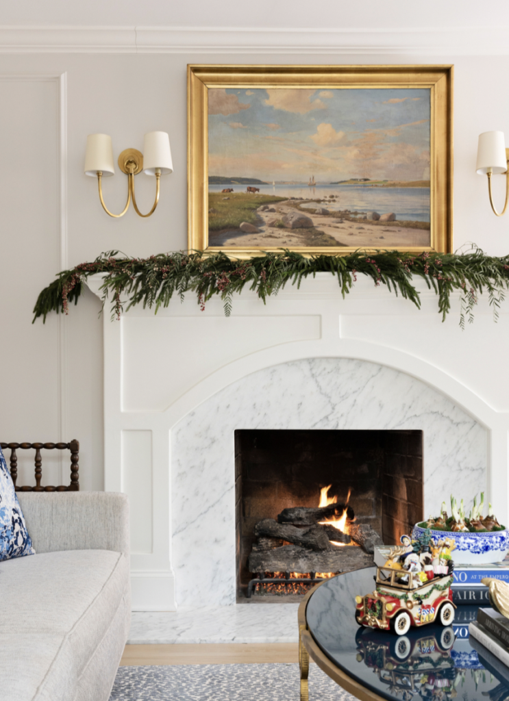 Gold Artwork and Sconce Above Fireplace