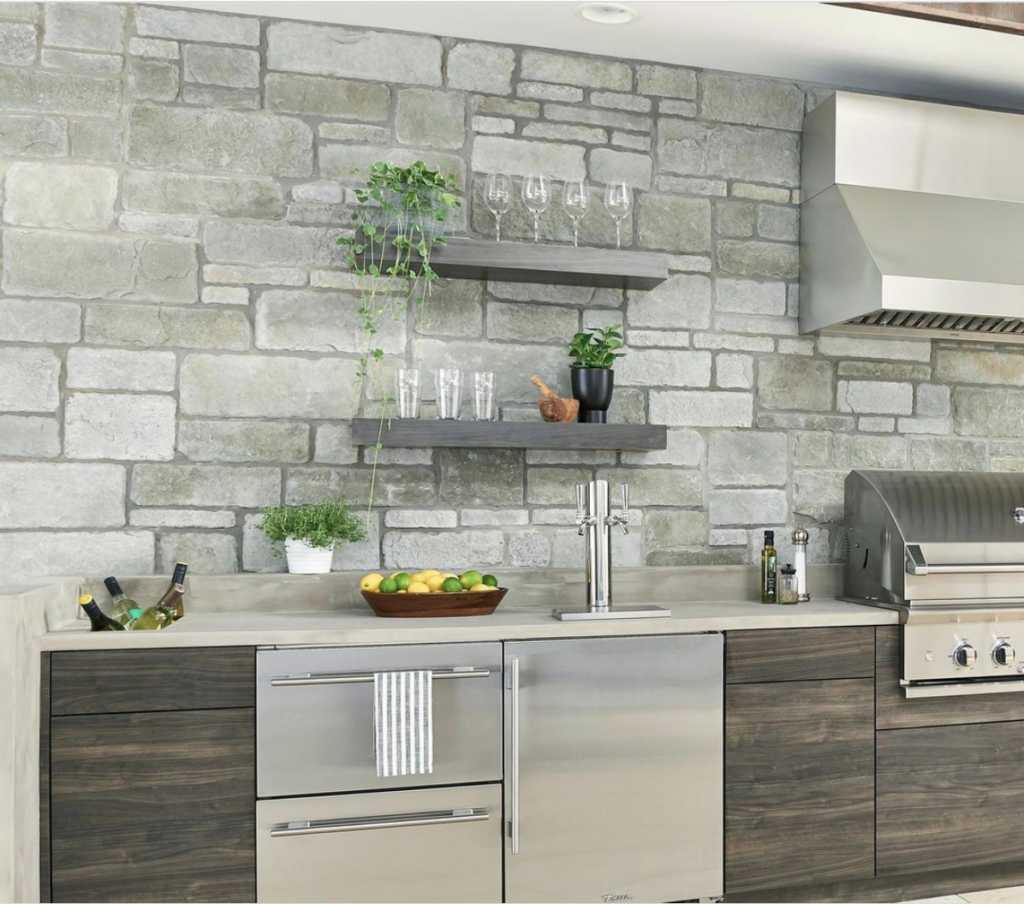 Gray Stone Accent Wall Kitchen with a Stainless Steel Appliance