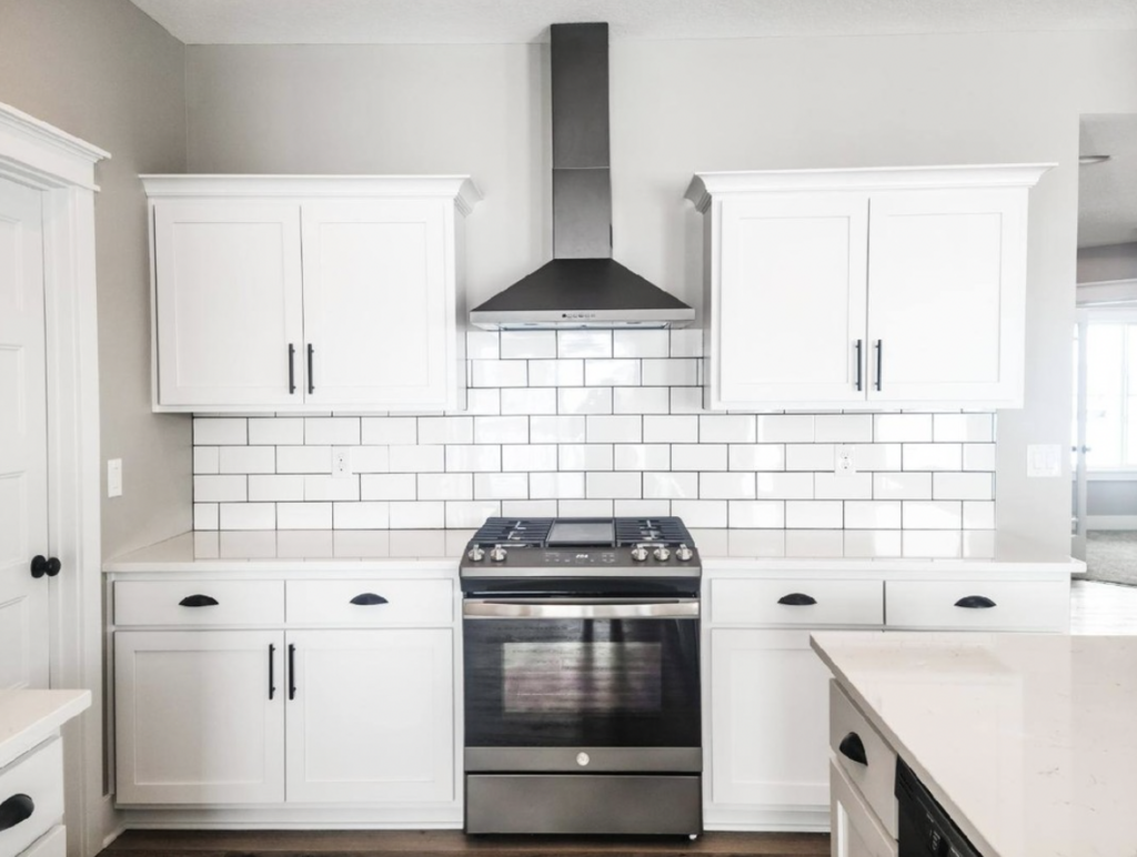 Kitchen Backsplash in Subway Tile Behind White Cabinets