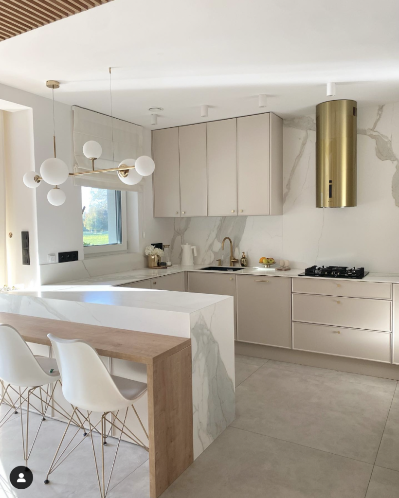 Light Beige Cabinets Paired with a Gold Cylindrical Vent