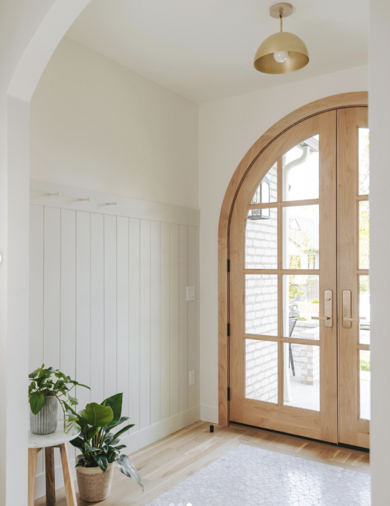 Light Wood Entryway Flooring and Arched Door
