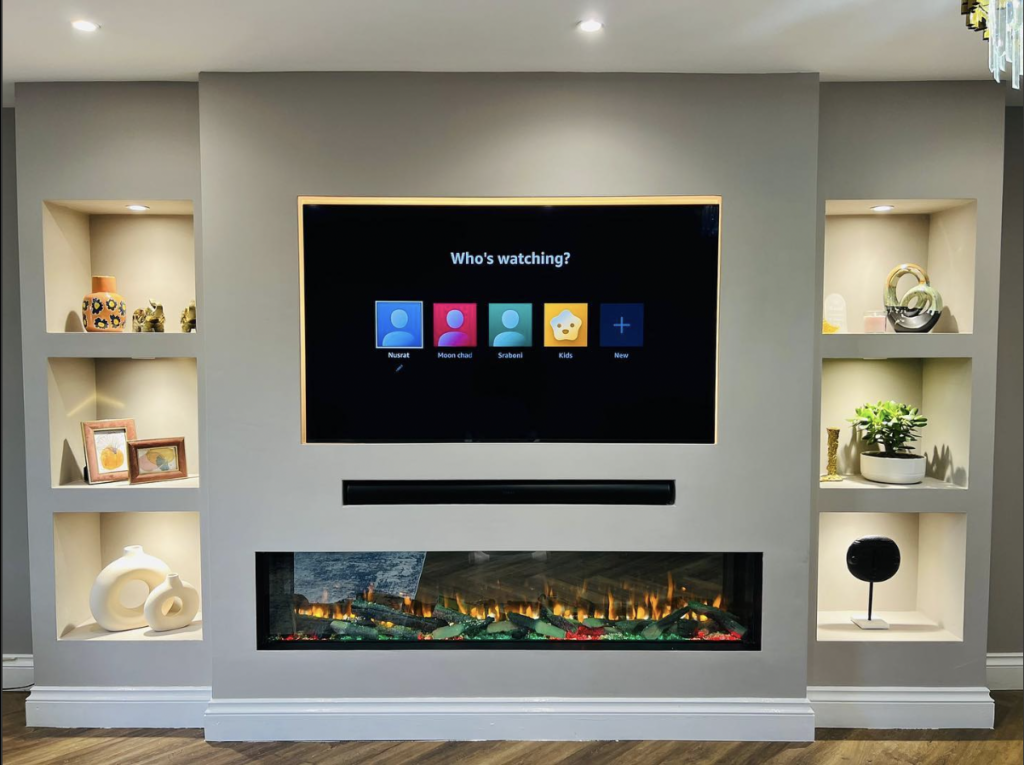 Electric fireplace integrated into full TV wall with venetian plaster finish