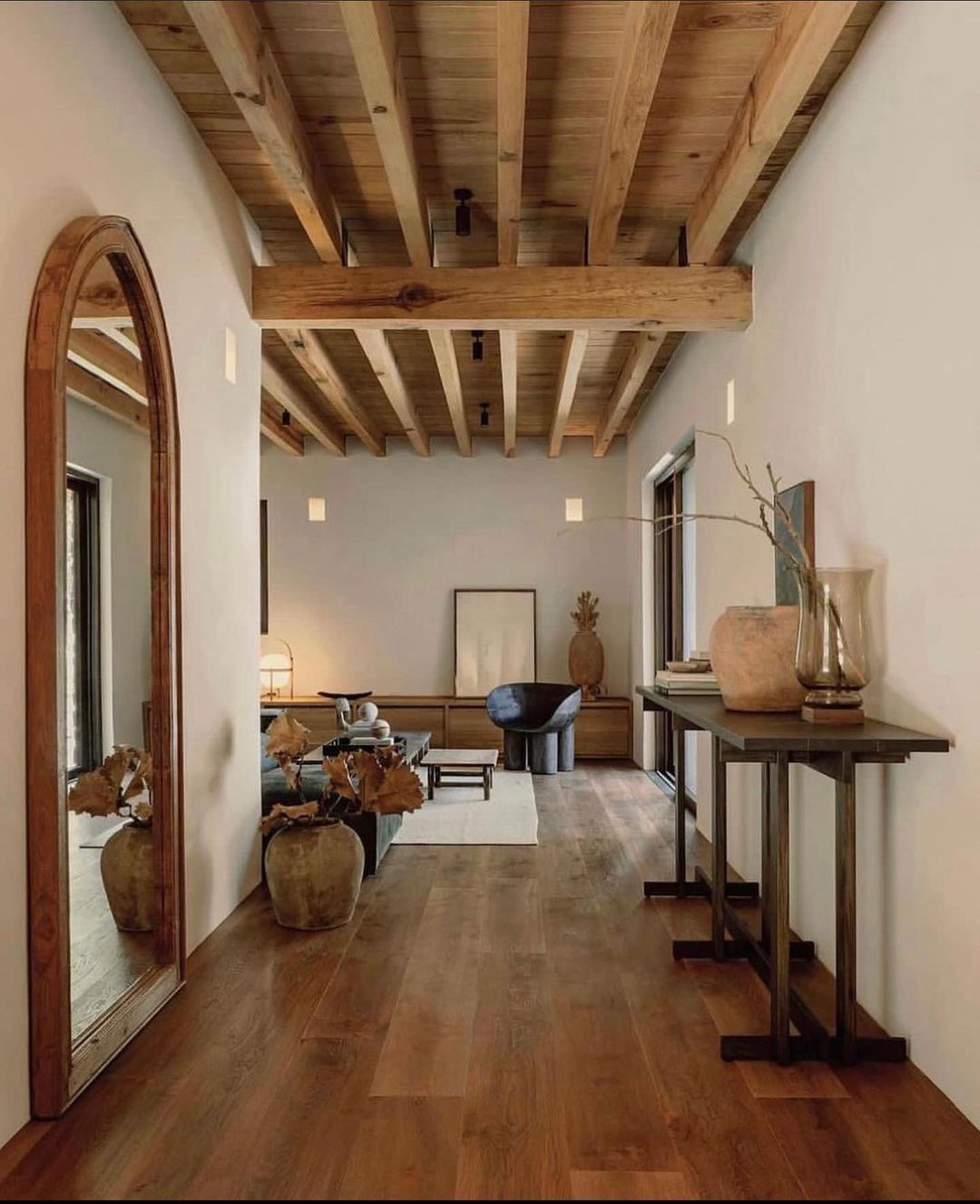 Minimalist living space with warm overhead wood beams