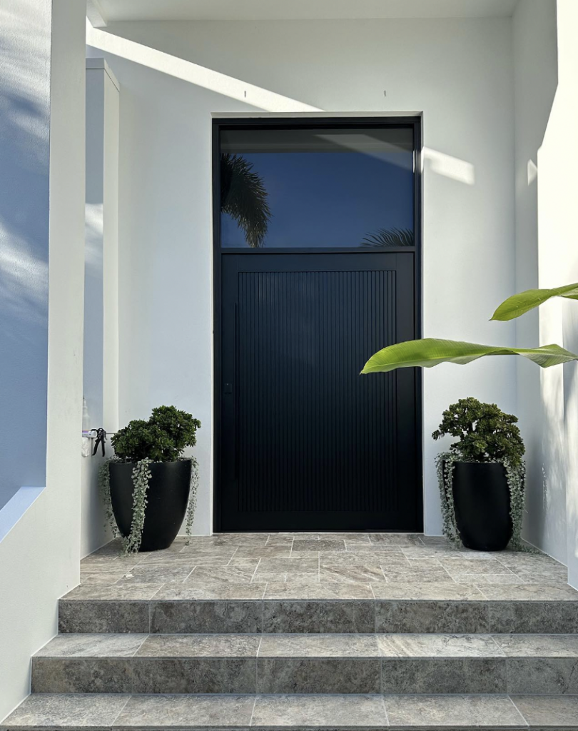 Modern front door in black with a sleek finish and upper glass
