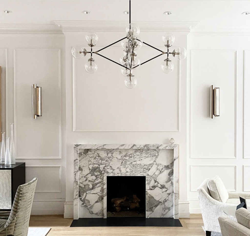 Modern Silver Sconces Paired with a Marble Fireplace