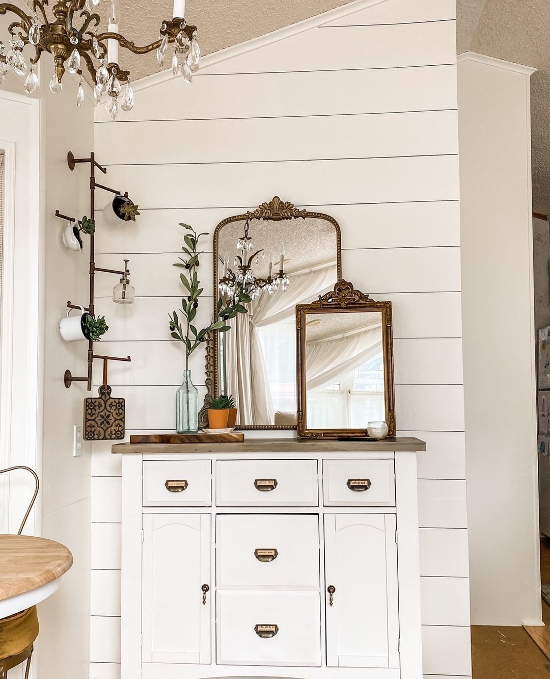Multiple Antique-Style Mirrors Above a Crisp White Cabinet