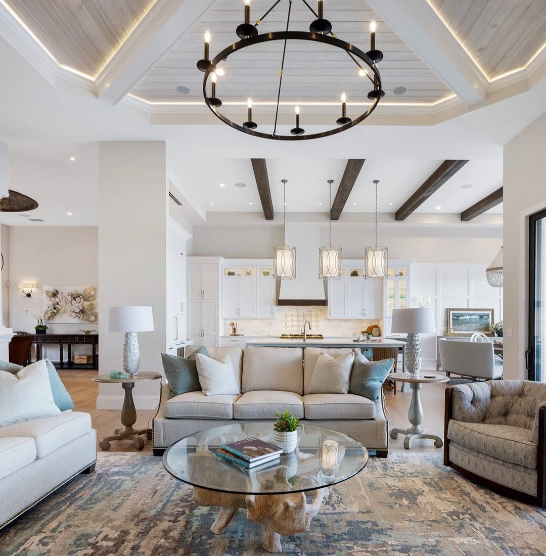 Open concept living space with dark sleek beams