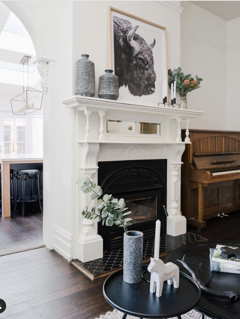 Patterned Black Tile Hearth for a White Fireplace