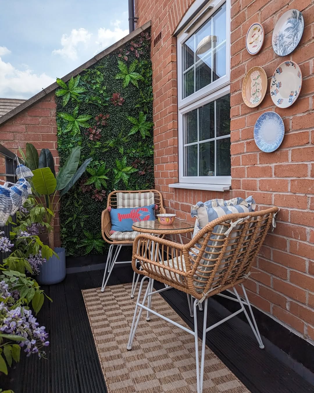 Rattan Chairs Framed By Vertical Greenery