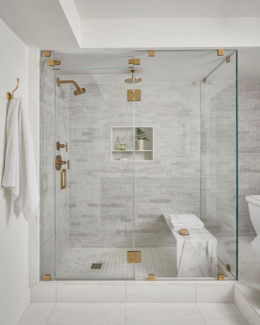 Elegant Marble Shower Pan with Bench and Brass Accents