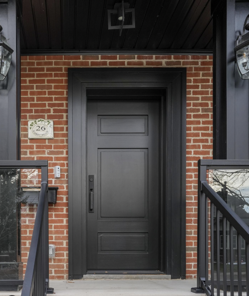 Reddish-Brown Brick House with a Black Front Door
