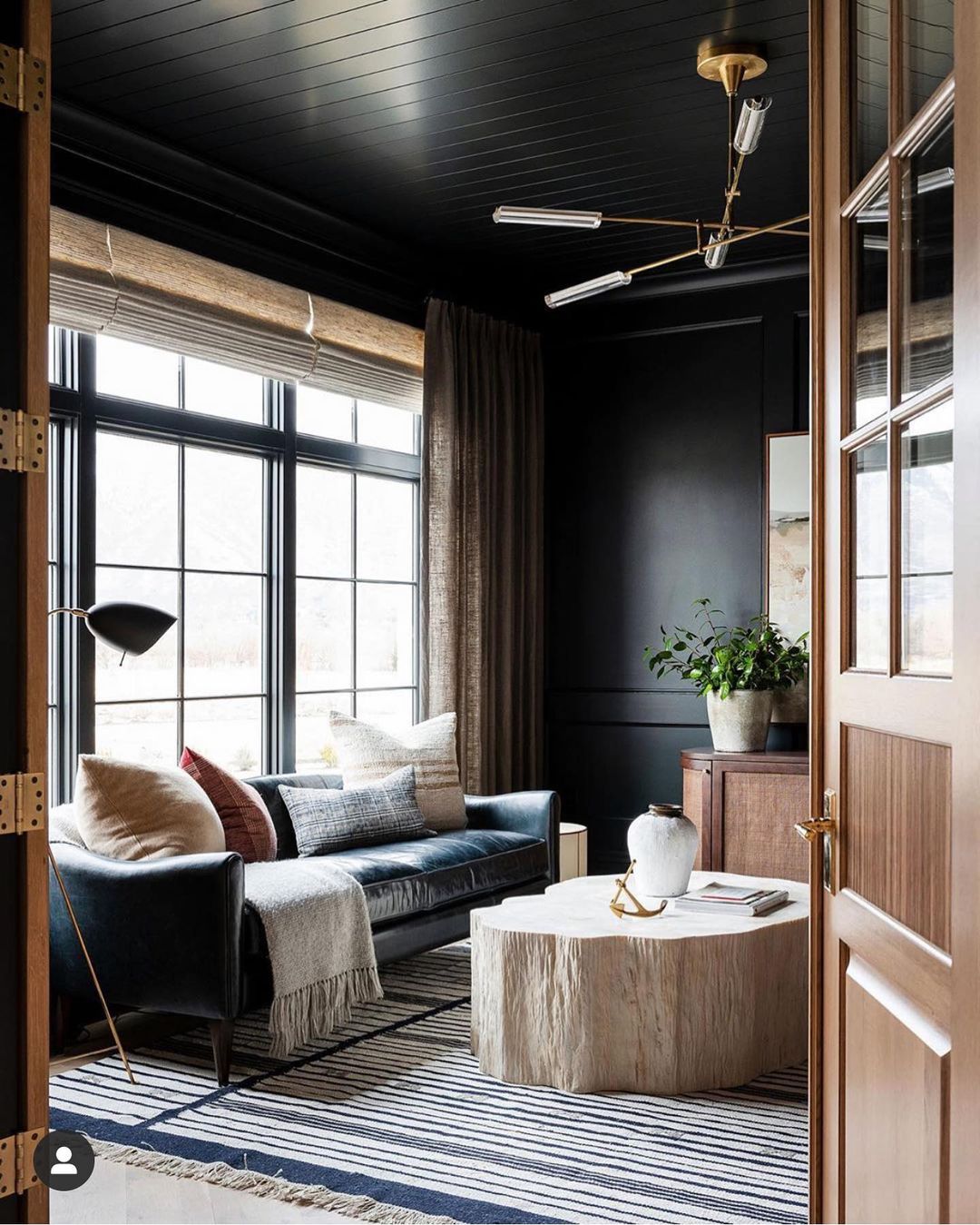Black Couch with Warm Wood and Rich Textures