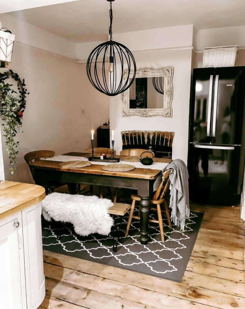 Rustic Room with Dining Area and Black Fridge